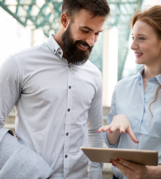 Business colleagues walking and talking on city streets